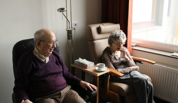 A man and a woman sitting on a chair