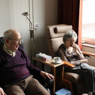 A man and a woman sitting on a chair